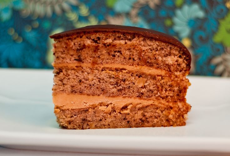 a piece of cake sitting on top of a white plate next to a blue and green wall