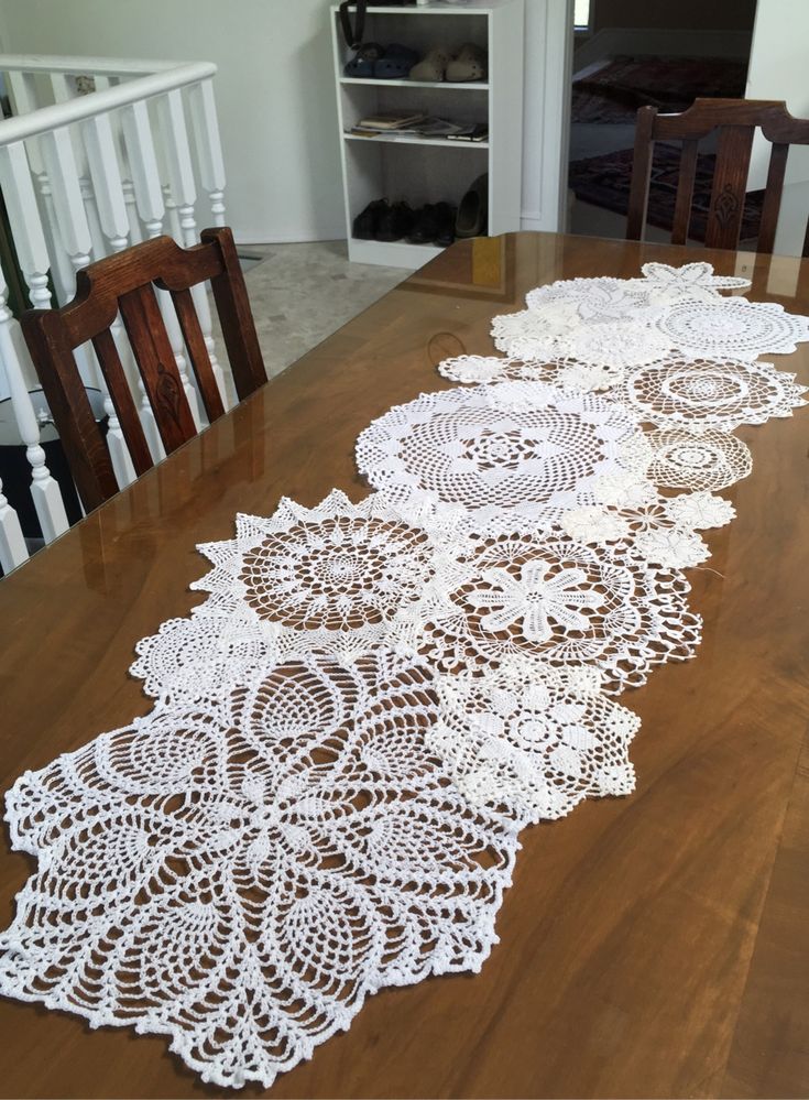 white crocheted doily sitting on top of a wooden table in a kitchen