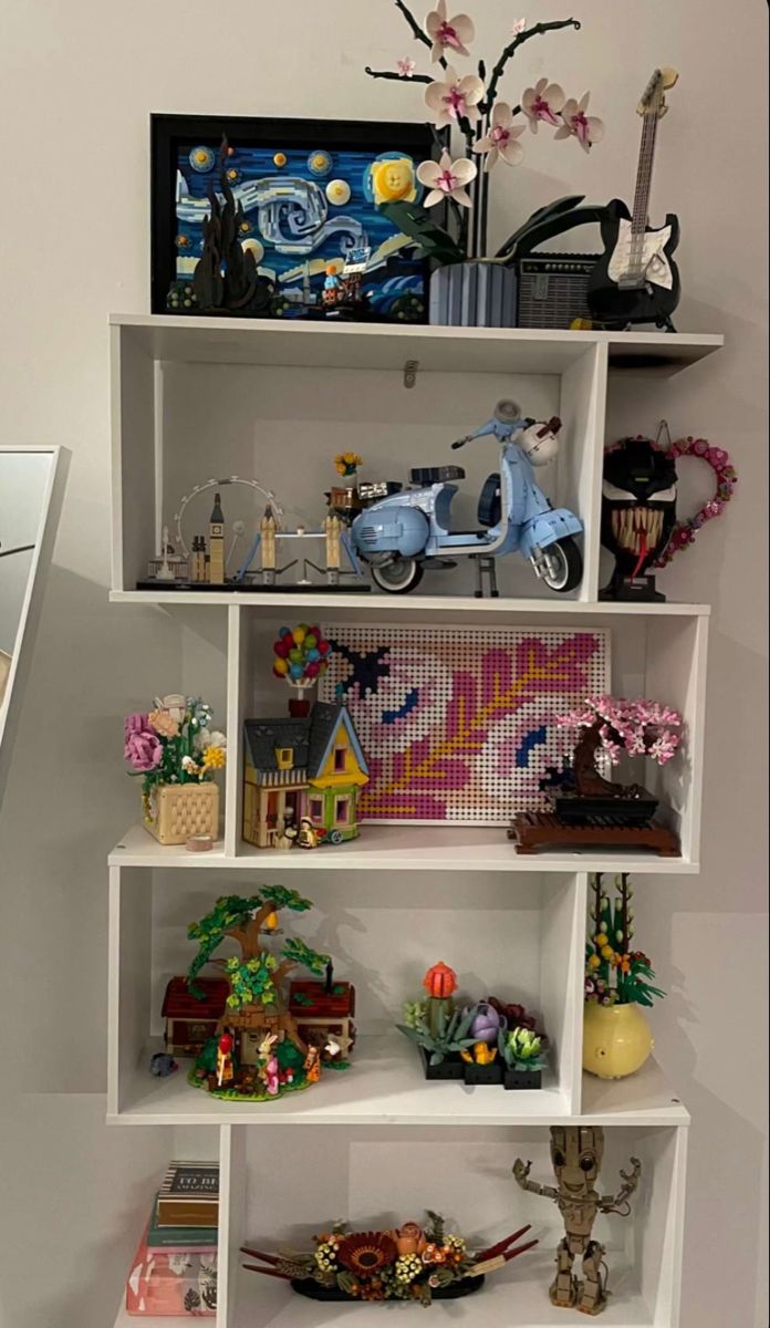 a white shelf filled with lots of toys and figurines