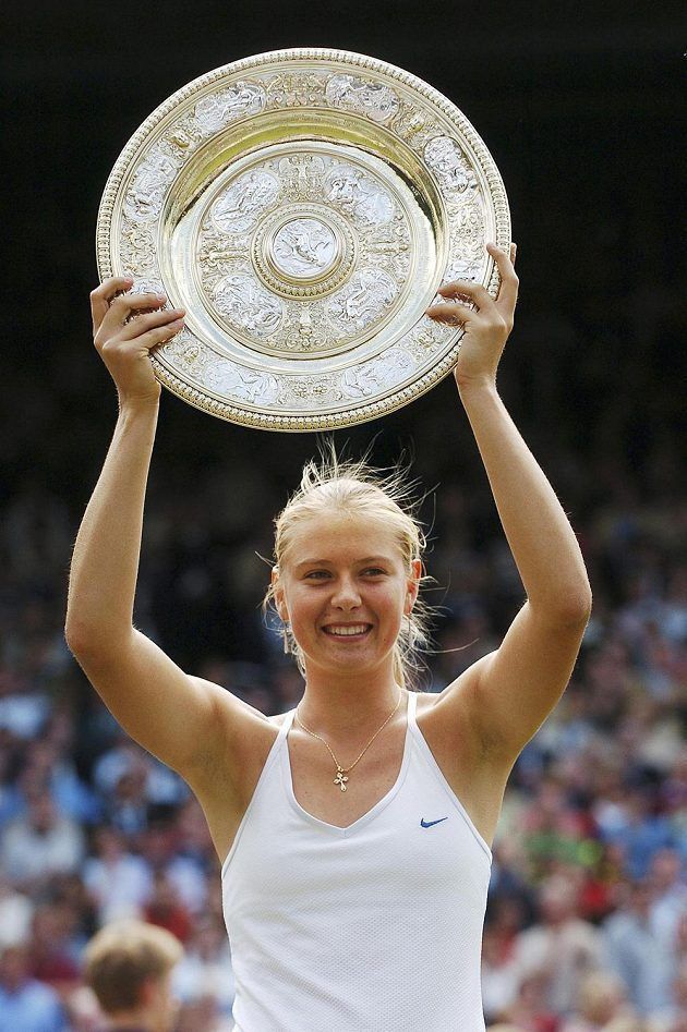 a female tennis player holding up a trophy