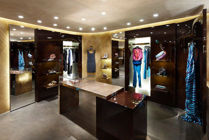 a room filled with lots of closet space and clothes hanging on the walls in front of them