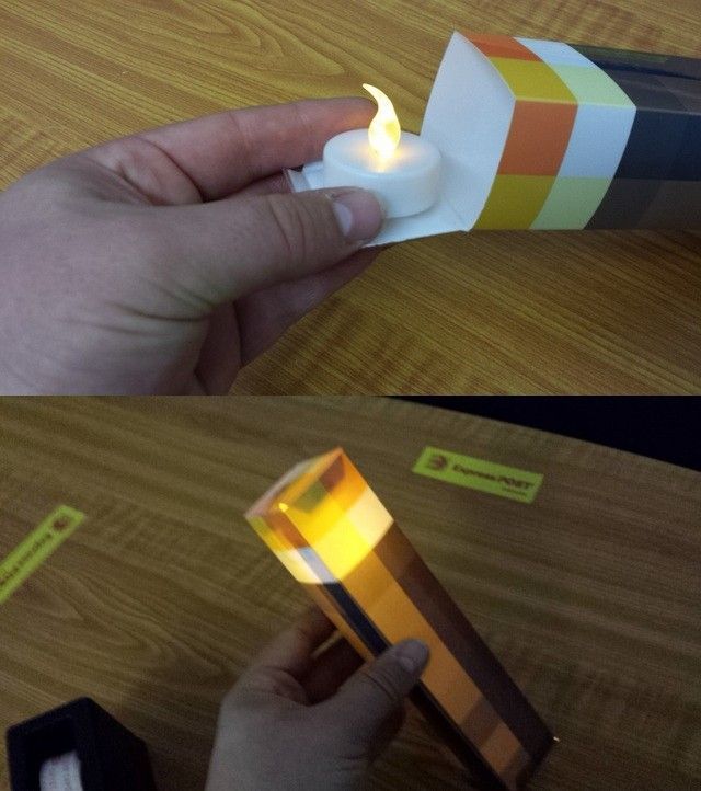 a person holding a lit candle in one hand and an empty lighter in the other