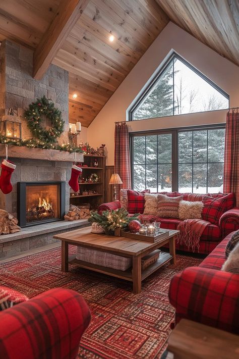 a living room filled with red couches and christmas stockings on the windowsills