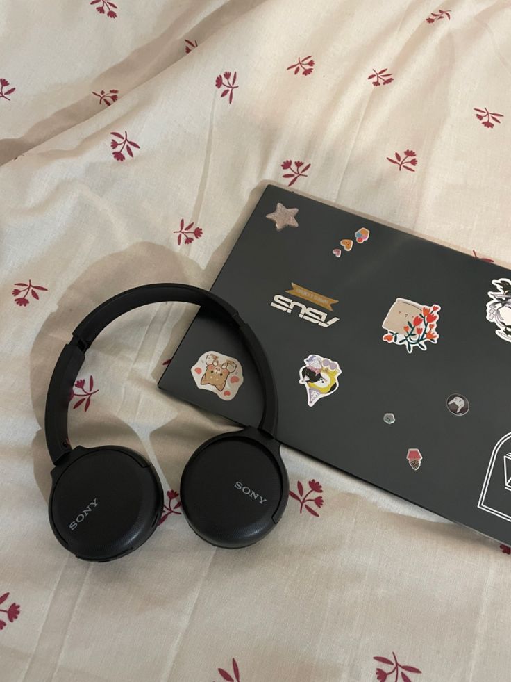 a pair of headphones sitting on top of a bed