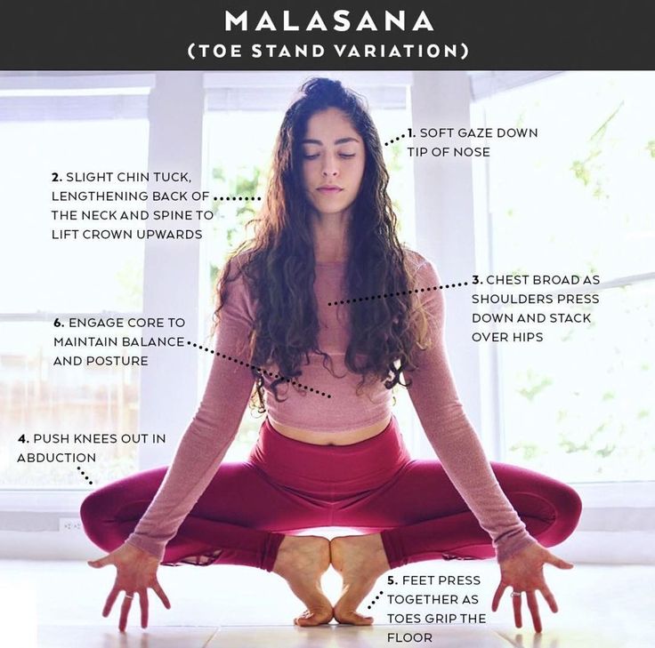 a woman is sitting in the middle of a yoga pose