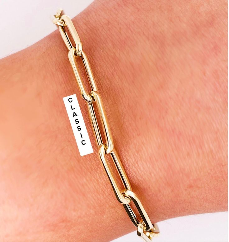 The Most Versatile & Fashionable Gold Bracelet You Will Ever Wear. Perfect On Its Own, As A Compliment To Other Gold or Diamond Bracelets Or Accented With Charms. Compare Our Link Size and Gold Weight To Anyone: Based on 7" Length La Petite 3.7mm wide x 12mm long (1/8" x 5/8") 2.6 Grams. Classic 5.3mm wide x 16mm long (1/4" x 1/2") 3.1 Grams. Grande 5.8mm wide x 21mm long (5/16" x 3/4") 4.5 Grams. OMG 9.0mm wide x 22mm long (3/8" x 7/8") 7..5 Grams AVAILABLE IN 14KT YELLOW & WHITE GOLD AVAILABLE IN VARIOUS SIZES IN STANDARD & CUSTOM LENGTHS. Contact Us For Custom Lengths and Pricing. UNIQUE LOBSTER CLASP ALLOWS YOU TO CUSTOMIZE THE LENGTH TO FIT THE DAYS WARDROBE. THE MATCHING NECKLACE MAKES A PERFECT COMBINATION 🔹FREE PRIORITY SHIPPING 🛩 Ready to Ship In 3 to 5 Days. RUSH ORDERS AVAILAB Classic Jewelry With Gold Clasp For Gift, Classic Jewelry With Gold Clasp Oval Link, Classic Gold-tone Jewelry With Gold Clasp, Classic Bangle Jewelry With Gold Clasp, Classic Bangle With Gold Clasp, Classic Gold-tone Chain Bracelet With Gold Clasp, Gold Oval Link Bracelet For Anniversary, Classic Bangle Jewelry With Box Clasp, Classic Bangle With Box Clasp