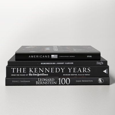 three books stacked on top of each other, one is black and the other is white