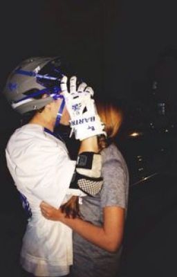 two people standing next to each other with helmets on their heads and one person wearing a glove