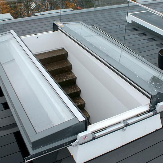 an open skylight on top of a roof with stairs leading up to the second floor