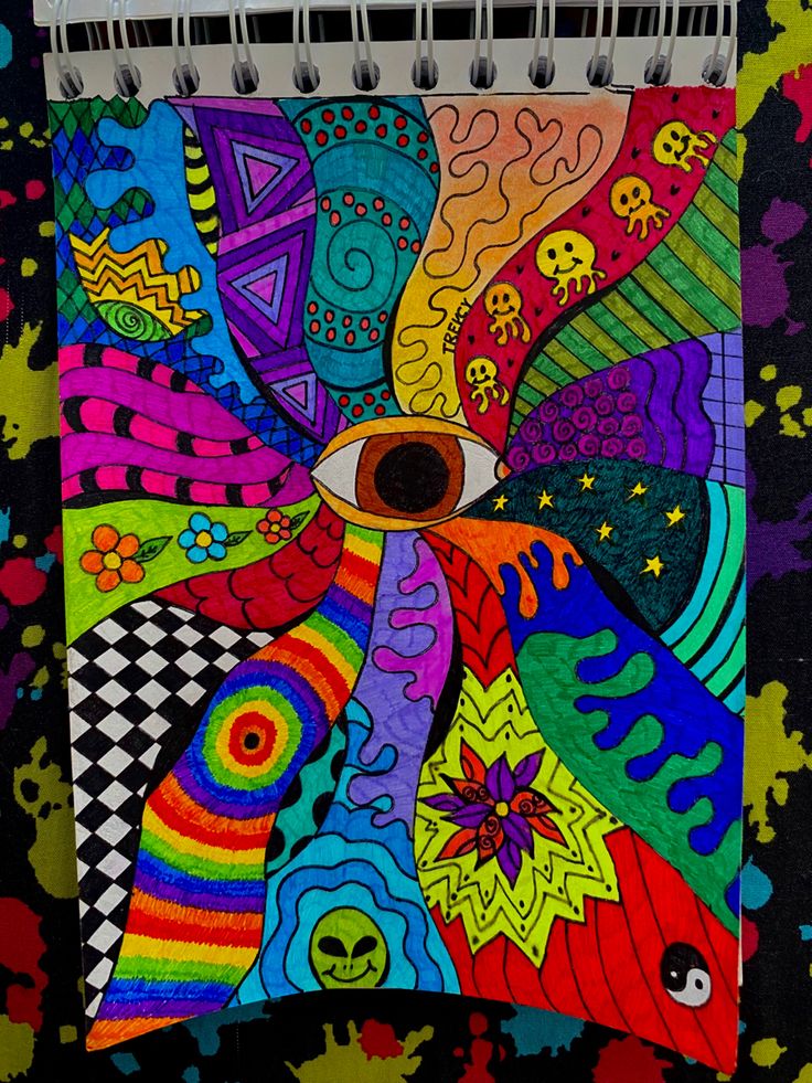 a colorful spiral notebook with an eye on it