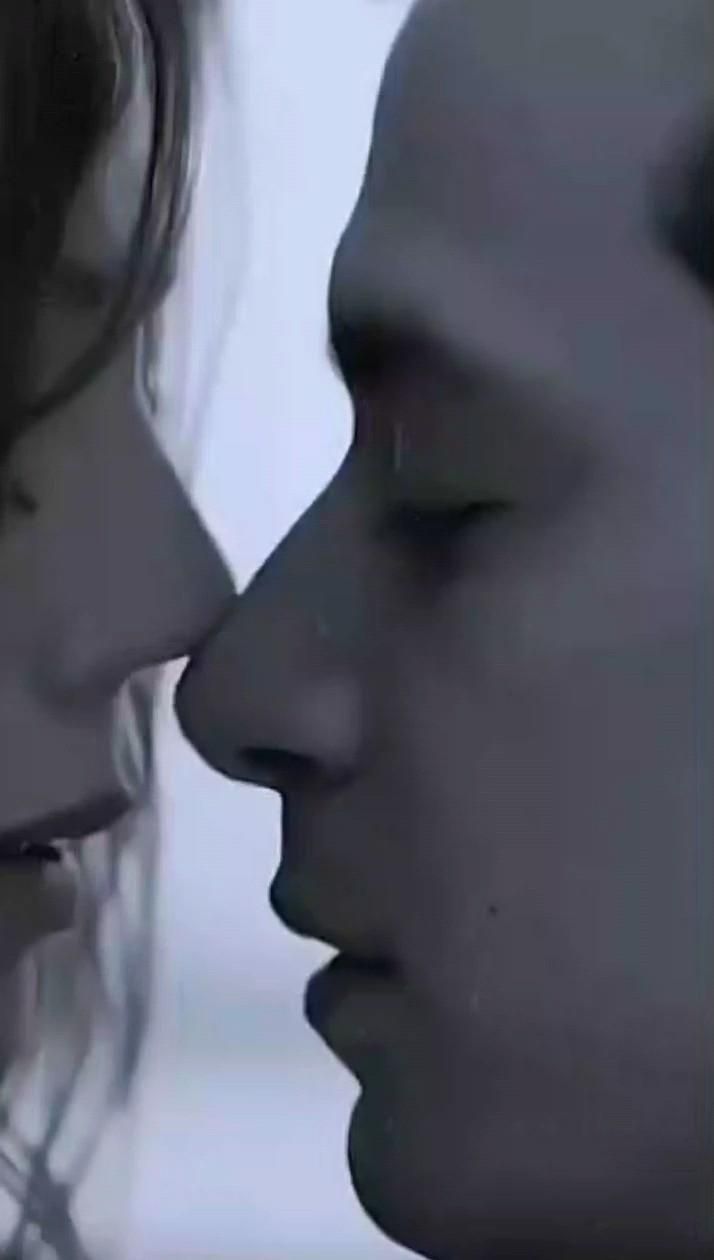 two people are kissing each other with their noses close together