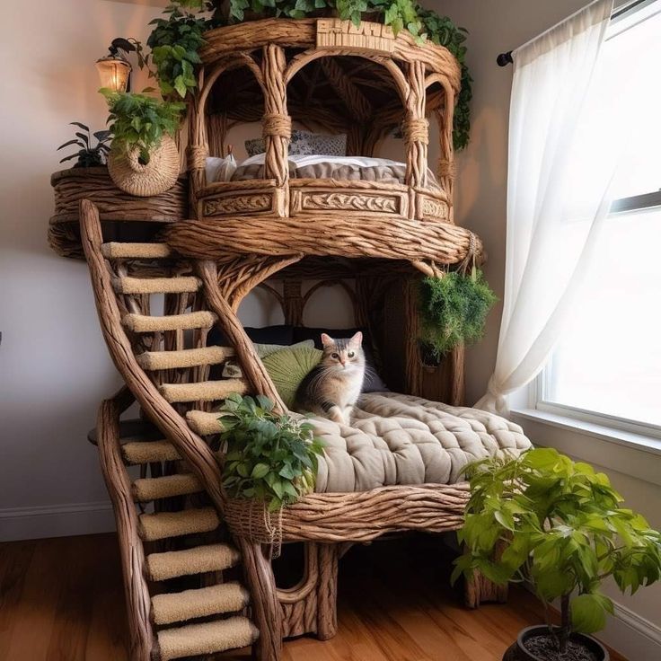 a cat sitting on top of a bed next to a plant in a window sill