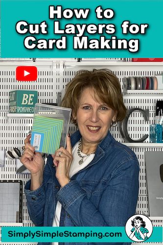 a woman holding up a card making kit