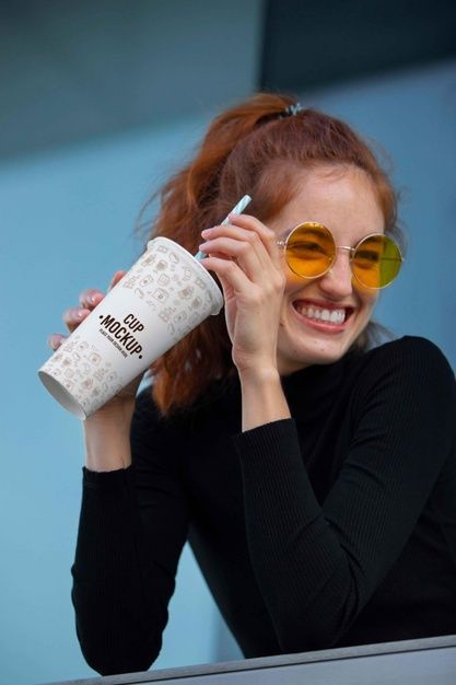 a woman wearing sunglasses and drinking from a coffee cup