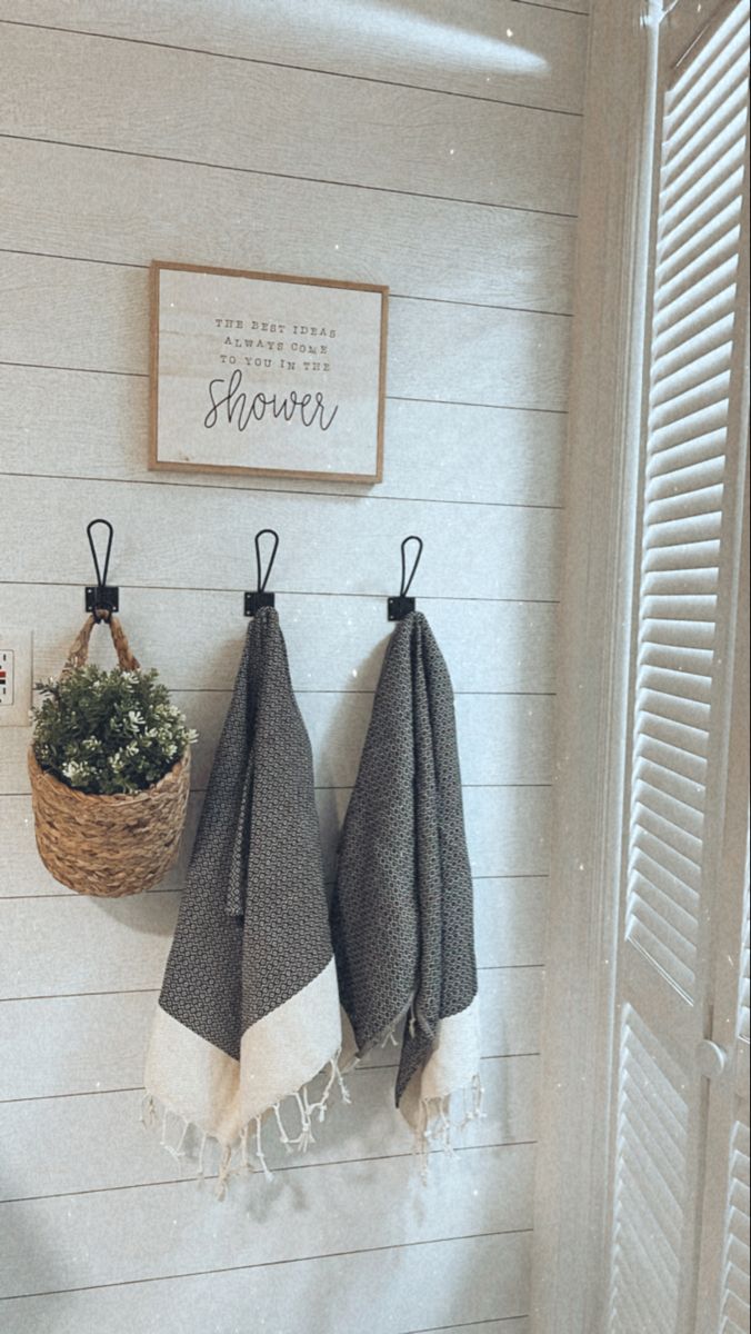 two towels hanging on the wall next to a basket