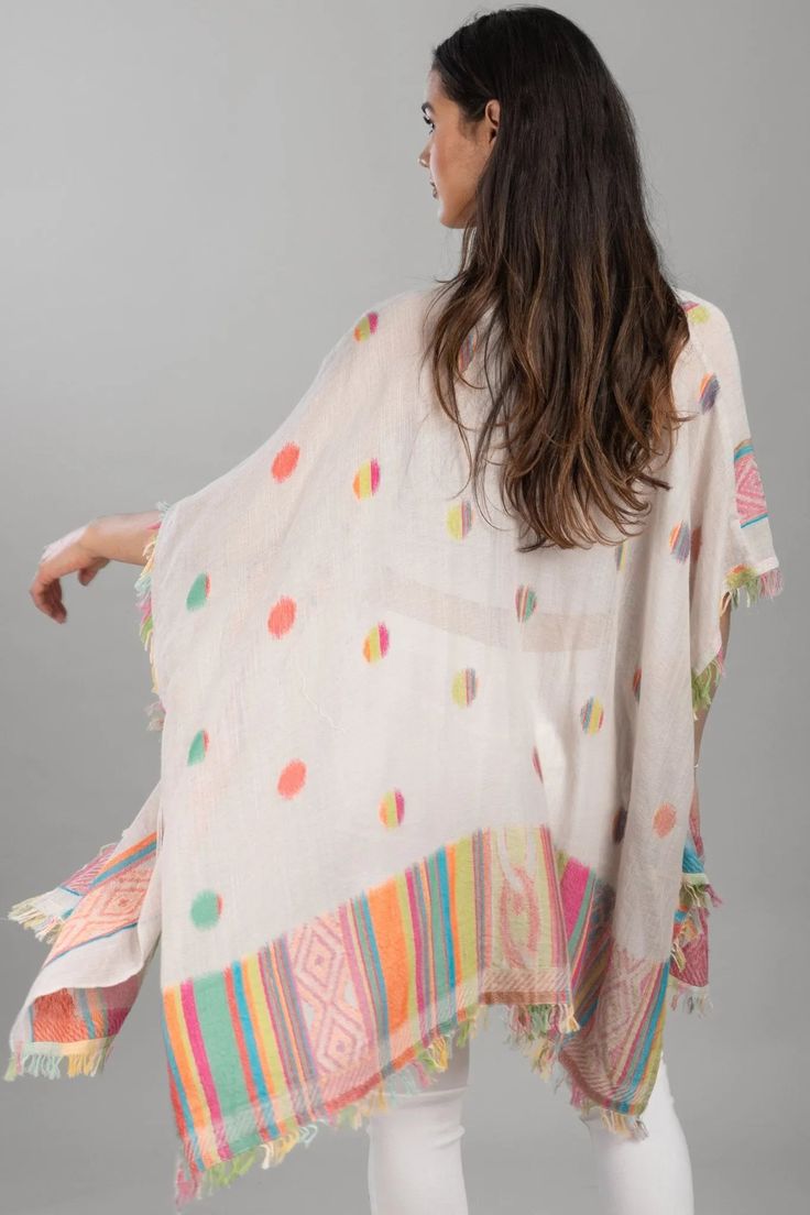 Brighten up your look with the Jacinda Kimono. This flamboyant design of multi-colored polka dots and a geometric patterned border is complete with snazzy eyelash fringe. Add a whimsical kimono to your collection this spring! Materials: 100% Cotton Size: 30" Long Made in India Multicolor Tassel Kaftan For Vacation, Multicolor Tasseled Kaftan For Vacation, Multicolor Vacation Kaftan With Tassels, Spring Multicolor Kaftan With Tassels, White Printed Kimono For Festival, Printed White Kimono For Festival, Multicolor Kimono With Tassels, Multicolor Kimono With Tassel Details, Summer Multicolor Ikat Print Kimono