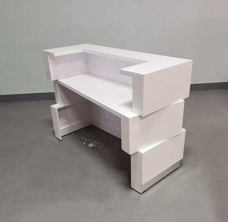 a white desk with three drawers on it