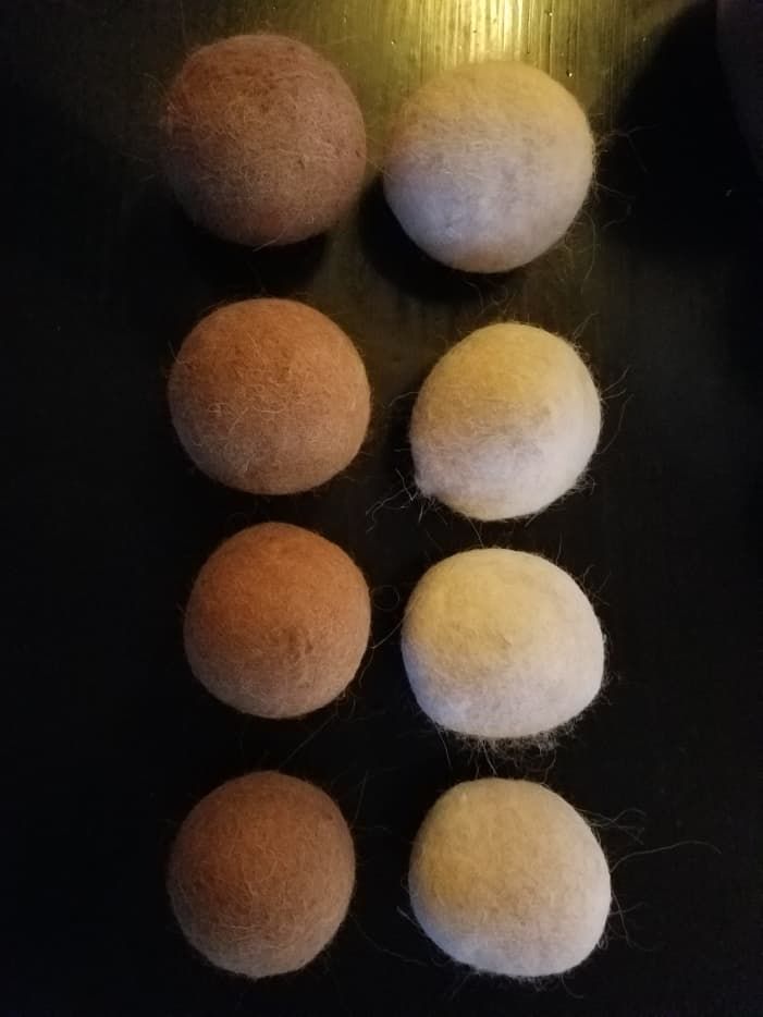 six balls of wool are arranged on a table top with one ball in the middle