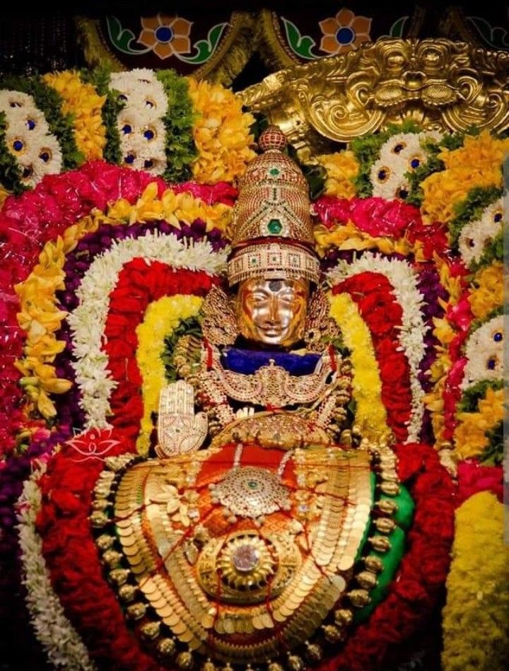 an idol is displayed in front of some flowers