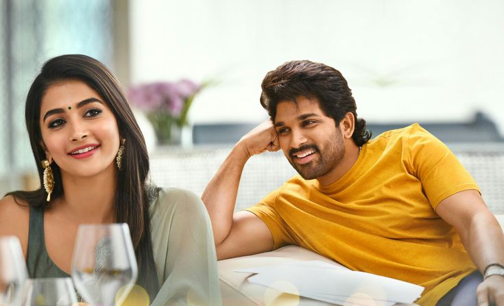 a man sitting next to a woman at a table with wine glasses in front of them