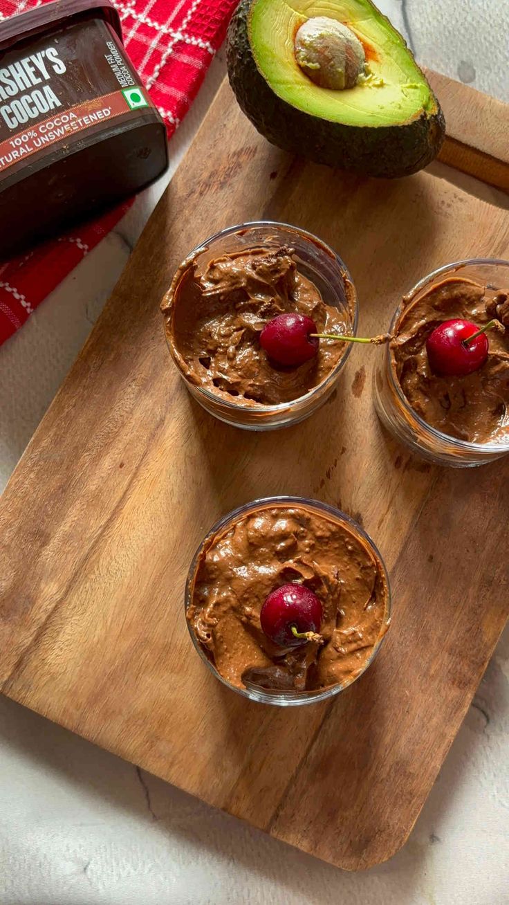 three desserts on a cutting board with an avocado and chocolate frosting