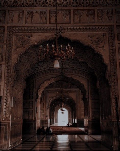 an ornate hallway with chandelier and marble flooring in the middle of it