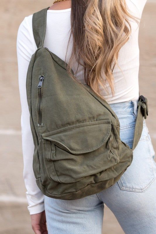 This roomy canvas sling bag is the perfect accessory for your wardrobe. Featuring an oversized design, its ample capacity is ideal for toting your everyday essentials. 100% Cotton Canvas Measurement: 13"x 4.5"x 16 Adjustable Strap from 10"-33" Side Zip Closure Front Velcro Pocket Front Zip Pocket Interior Small Zip Pocket Canvas Sling Bag, Mode Shoes, Sling Pack, Sling Bag, Canvas Bag, Hat Hairstyles, Handbag Accessories, Side Zip, Apparel Accessories