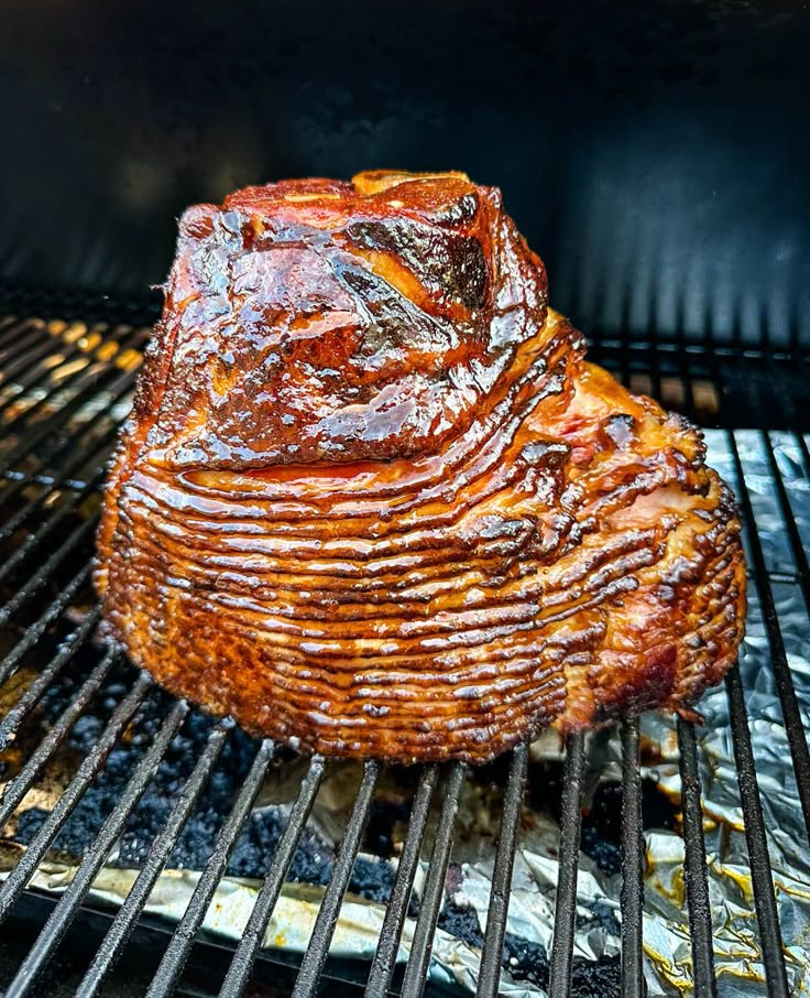 a piece of meat is cooking on the grill