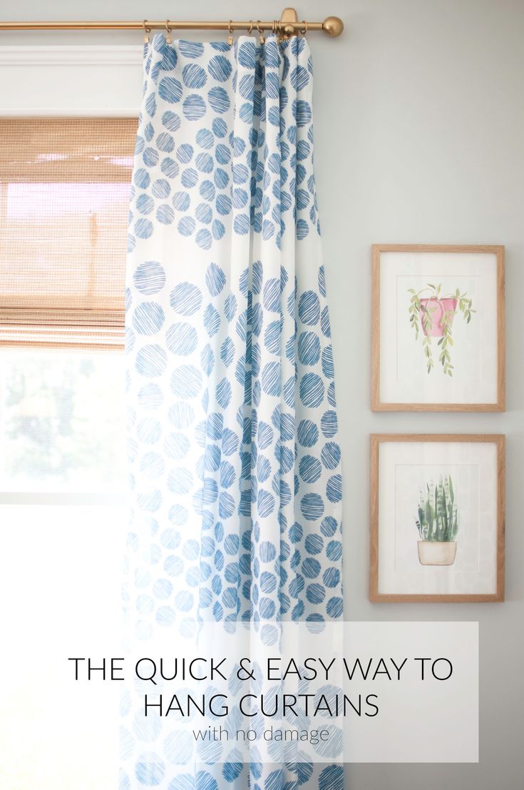 the quick and easy way to hang curtains with pictures on the wall behind it in between two frames