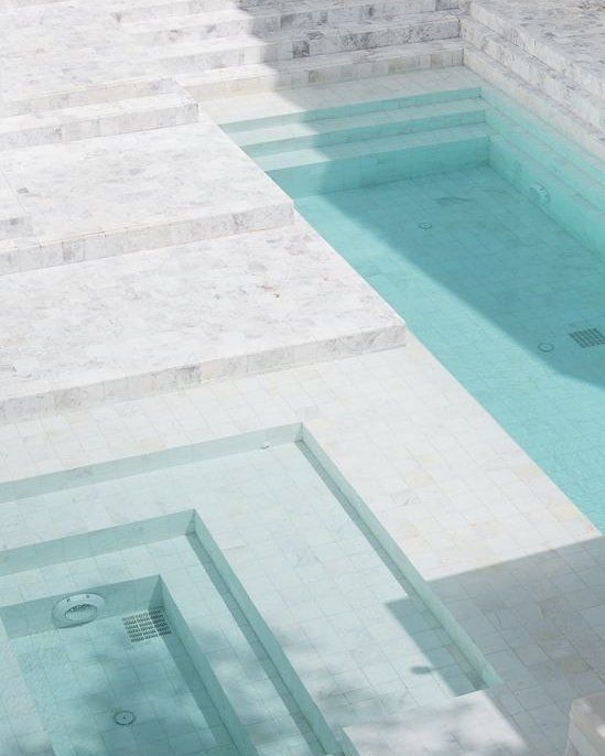 an empty swimming pool with steps leading up to it