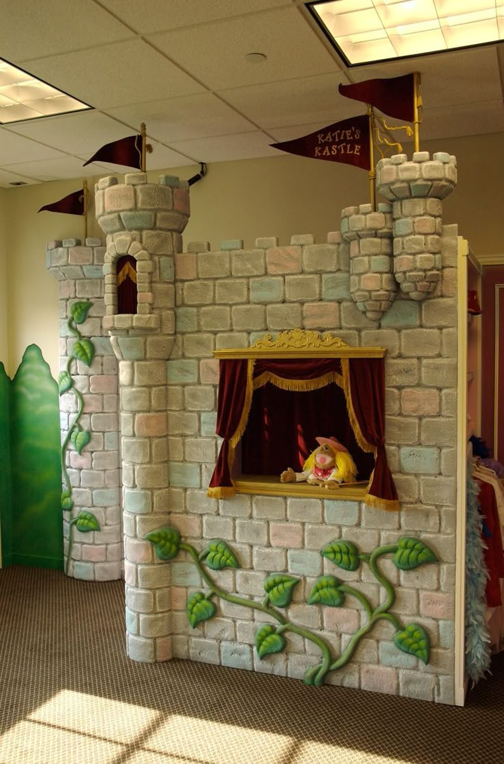 an indoor play area with a fake brick castle