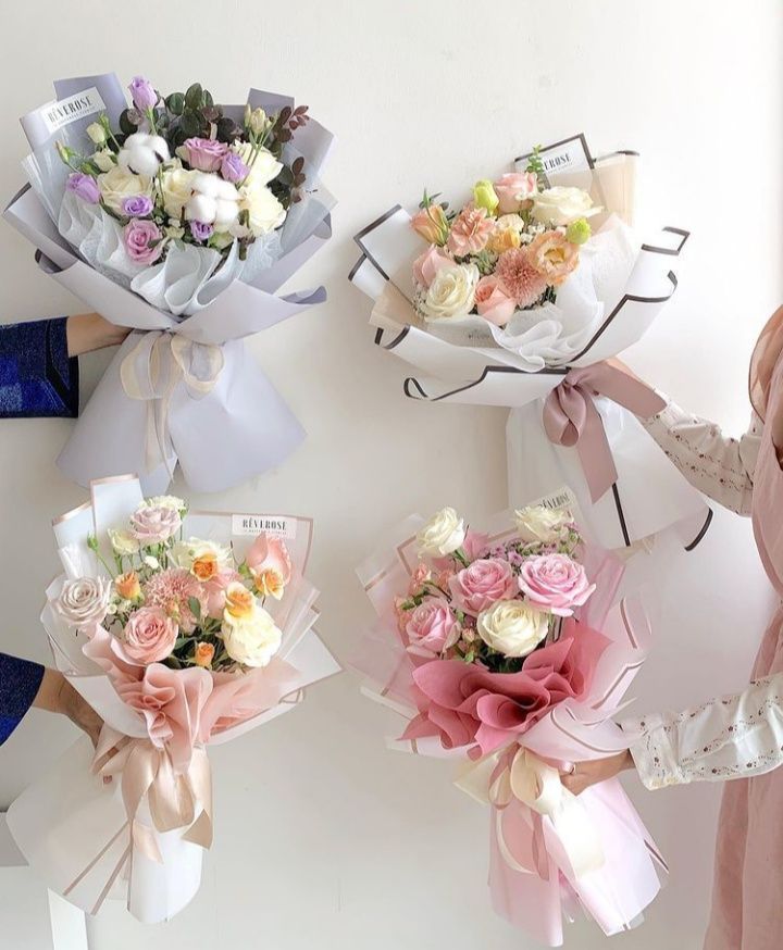 three women holding bouquets of flowers in their hands