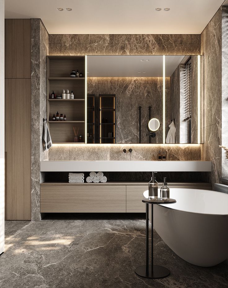 an elegant bathroom with marble walls and flooring, large mirror above the bathtub