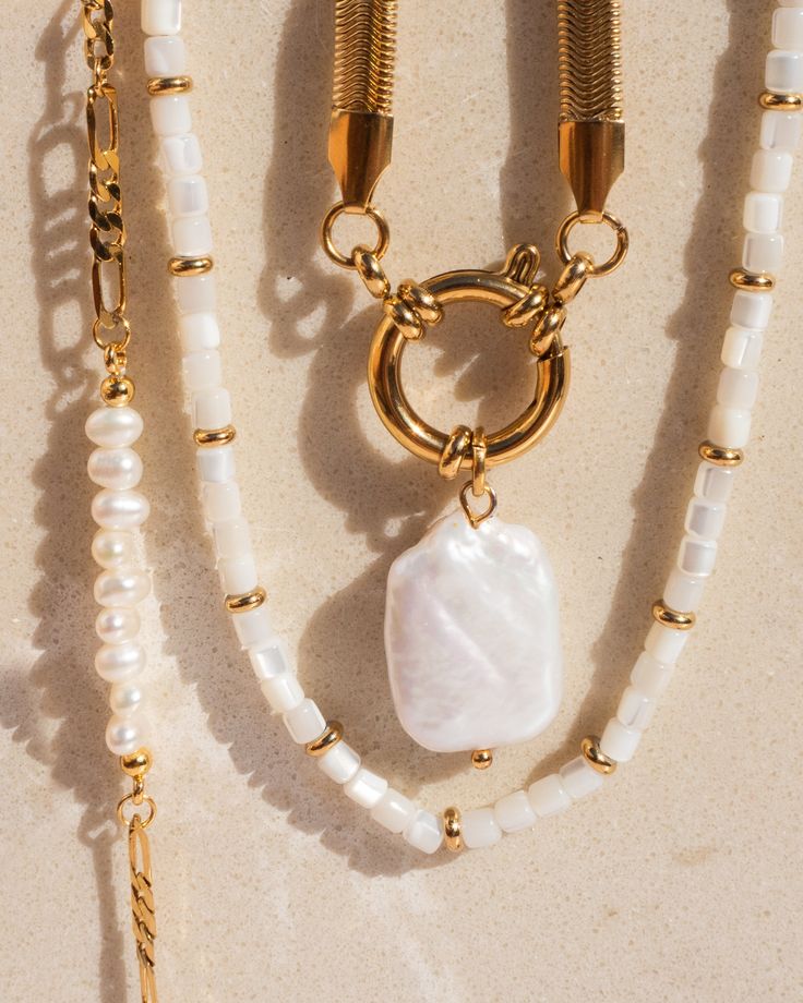 Mother of Pearl and Gold Necklace Length: approx. 15.5- 17.5 inches (adjustable) Natural Mother of Pearl 18K Gold Plated Stainless Steel This necklace is made with natural gemstones, therefore each necklace is unique.