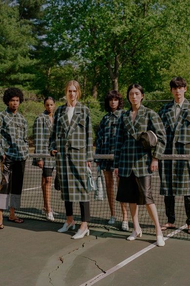 a group of people standing next to each other on a tennis court