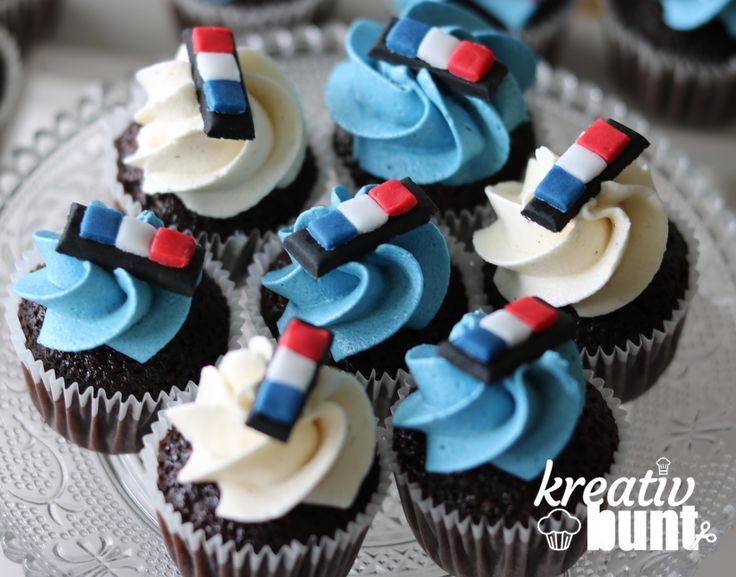 cupcakes with blue frosting and red white and blue icing on them