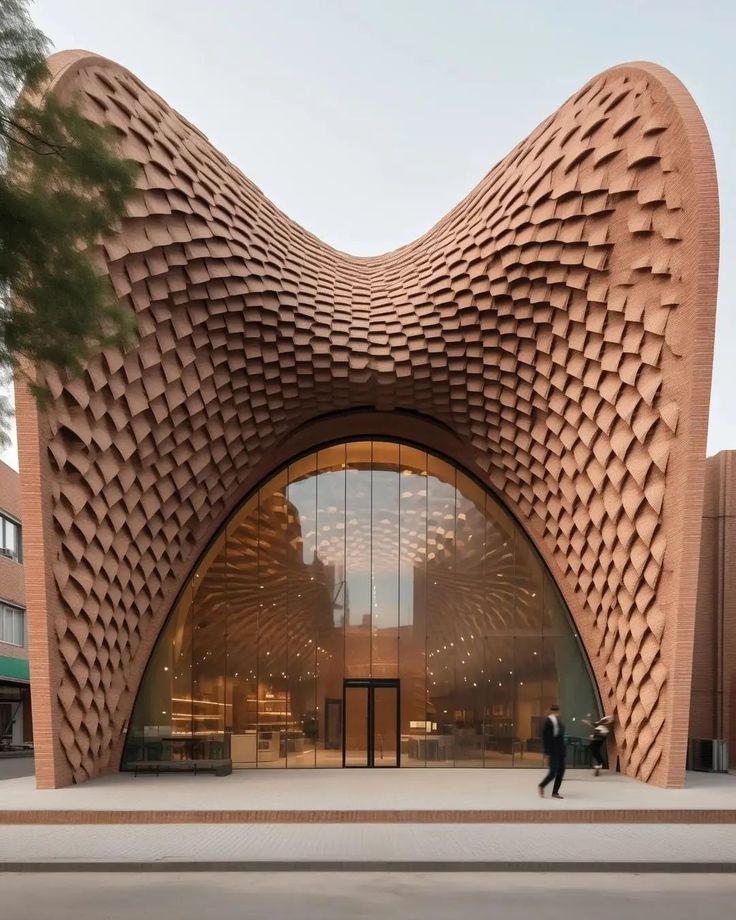 a large building with an intricate design on it's face and side entrance, as well as people walking by