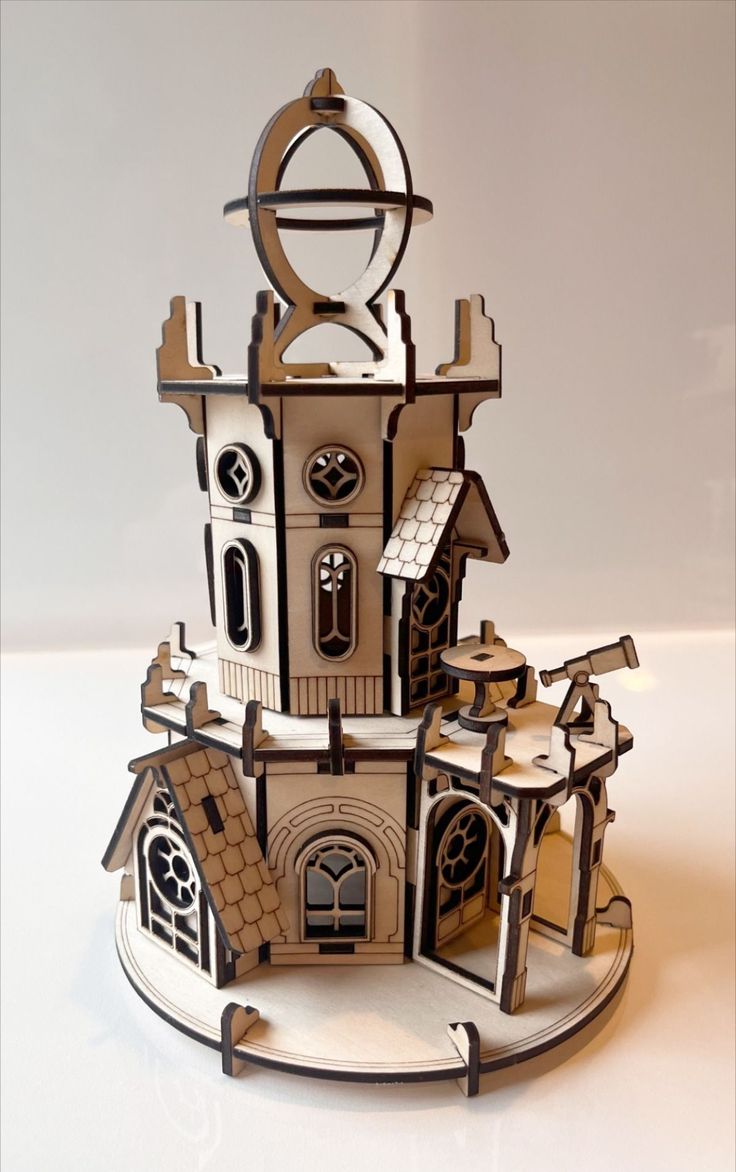 a paper model of a house with a clock on it