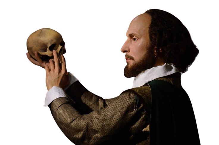 a man holding a skull in one hand and wearing a cape on the other side