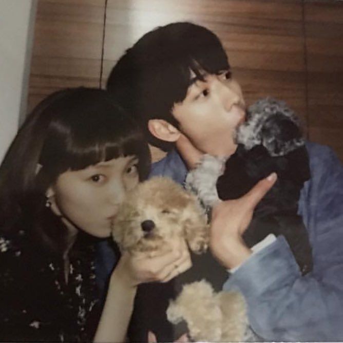 two children and a dog are posing for a photo with their stuffed animals in front of them