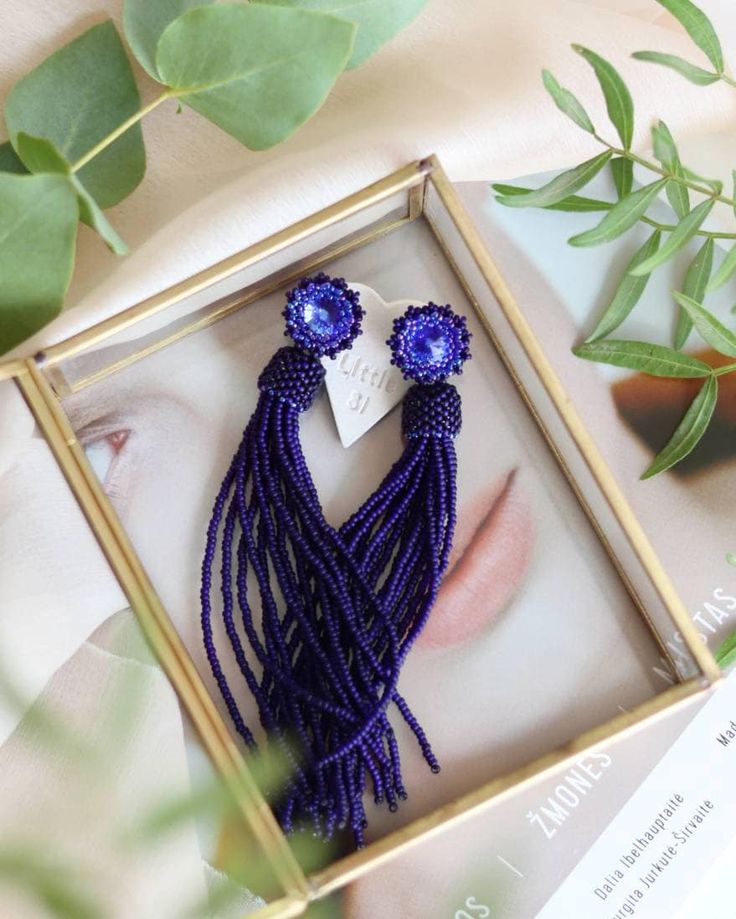 Add a touch of elegance to your outfit with these stunning matte blue beaded tassel earrings. The deep navy blue dangle earrings feature Swarovski crystal studs that add a hint of sparkle to your look. These bohemian-inspired fringe earrings are both trendy and chic, making them the perfect accessory for any occasion. Whether you're dressing up for a special event or adding a stylish touch to your everyday outfit, these seed bead earrings are sure to make a statement. Elevate your style with the Bohemian Dangle Earrings For Evening, Blue Fringe Dangle Chandelier Earrings, Elegant Tassel Earrings With Fringe As Gift, Evening Long Drop Tassel Earrings, Blue Tassel Earrings With Round Beads, Tassel Drop Earrings For Evening, Party Beaded Fringe Earrings Adjustable, Evening Tassel Dangle Jewelry, Evening Dangle Tassel Jewelry