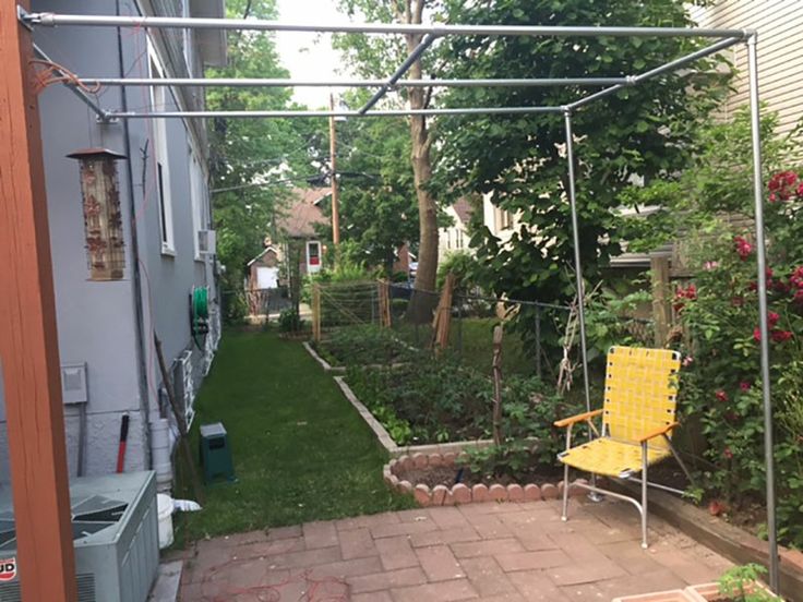 a yellow chair sitting in the middle of a yard