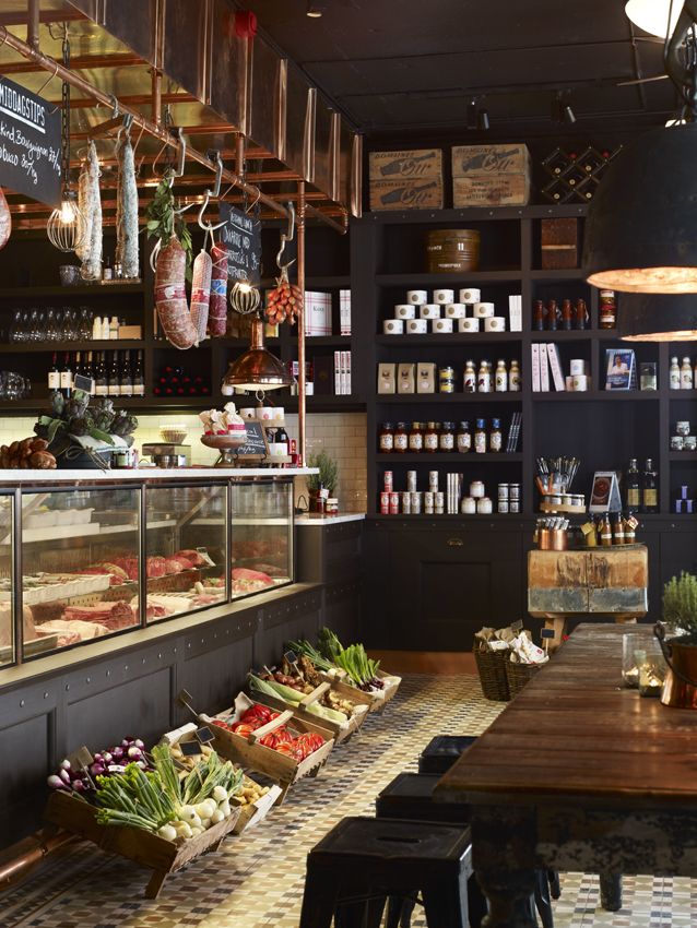 the inside of a restaurant with lots of food on tables and shelves filled with condiments