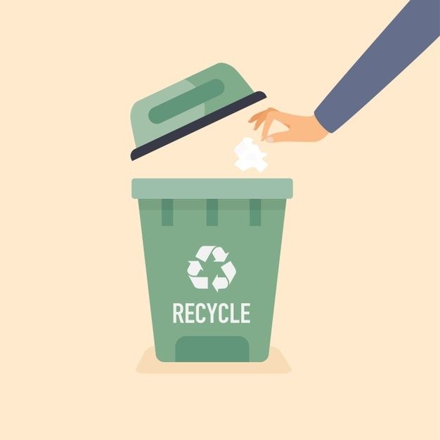 a person throwing garbage into a green recycle bin