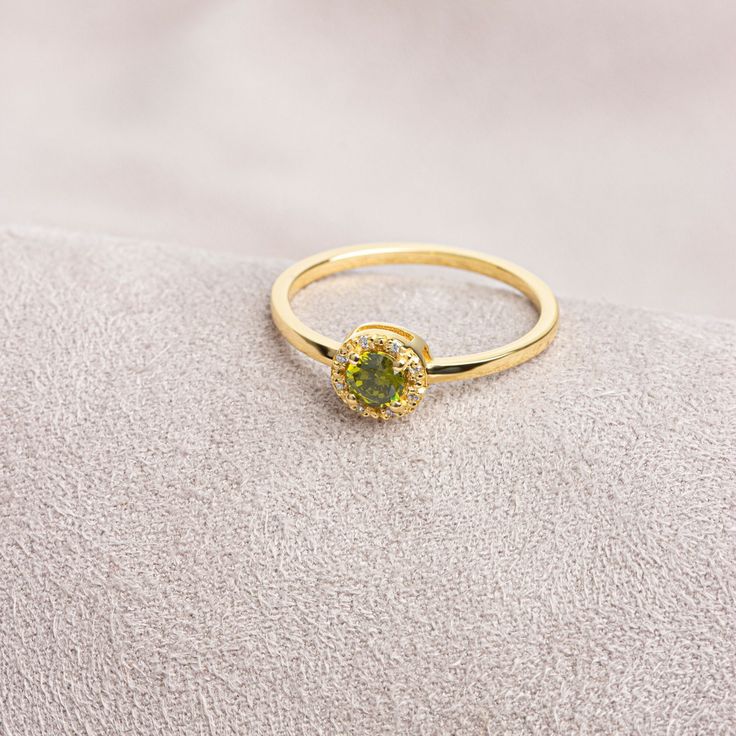 "Peridot: This stone, called the \"Emerald of the Night\" in ancient Egypt, is believed to protect the person using it like a shield. Our round cut ring with peridot stones surrounded by real diamonds is produced to always be with you. It can be given as a gift to yourself, your friends, your lover or your mother. Crown your happy days with our ring. We hope you create beautiful memories with our ring.   Peridot is the birthstone for those born in August. Don't forget to visit our store for all Green 14k Gold Diamond Promise Ring, Green Diamond Promise Ring In 14k Gold, Green 14k Gold Promise Birthstone Ring, Gold Crystal Promise Ring For May Birthstone, Green Gemstone Promise Birthstone Ring, Green Peridot Promise Jewelry, Green Peridot Jewelry For Promise, Emerald Crystal Ring In Yellow Gold, Yellow Gold Peridot Diamond Ring With Birthstone