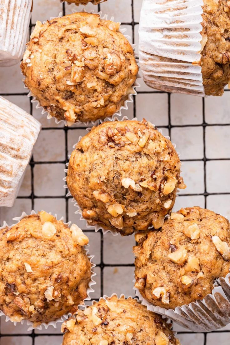 muffins on a wire cooling rack with other muffins in the background