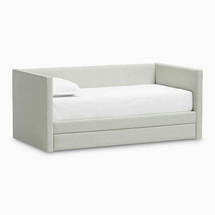 a white daybed sitting on top of a white floor