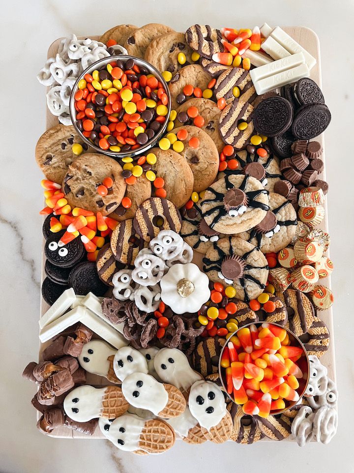 a platter filled with halloween cookies and candy