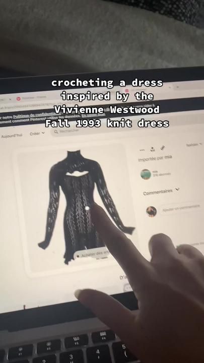 a person is pointing at a screen with an image of a woman's dress on it