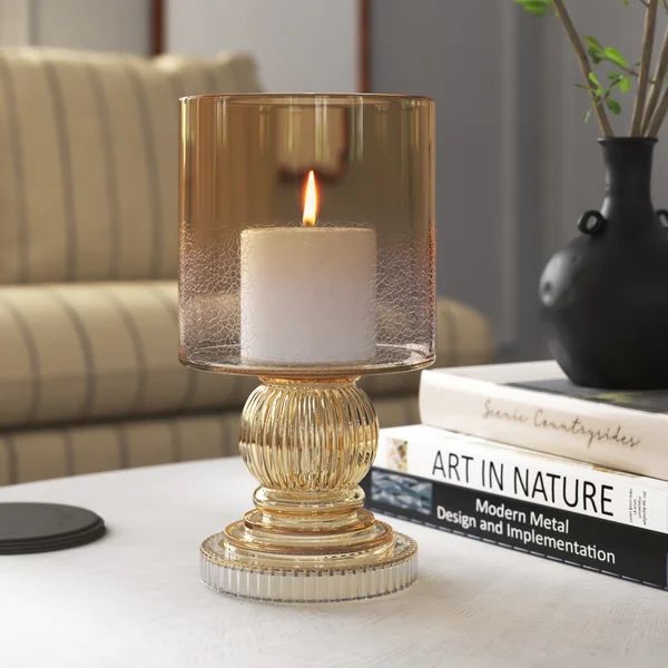 a candle is sitting on a table next to some books